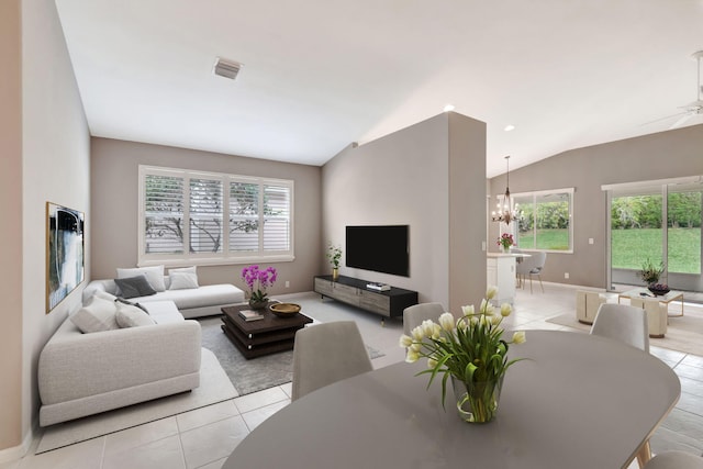 living room with lofted ceiling, light tile patterned floors, plenty of natural light, and visible vents