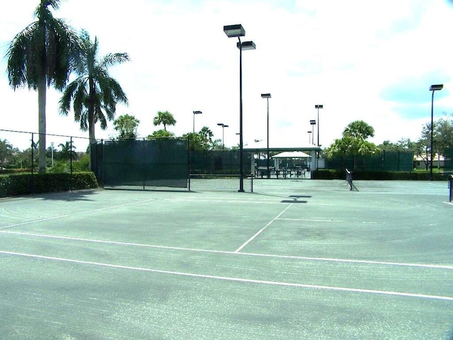 view of sport court featuring fence