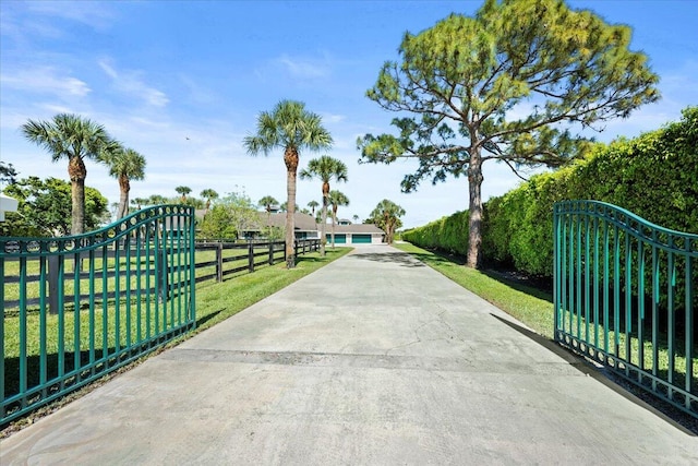 view of gate featuring a yard and fence