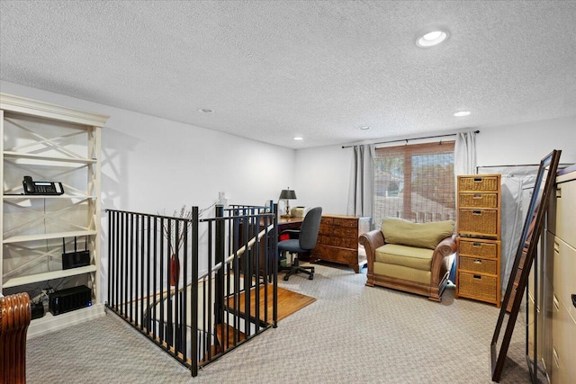 office area with a textured ceiling, carpet floors, and recessed lighting