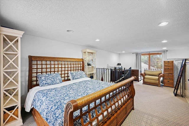 carpeted bedroom with a textured ceiling and recessed lighting