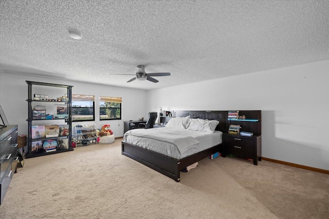 bedroom with carpet floors, ceiling fan, a textured ceiling, and baseboards