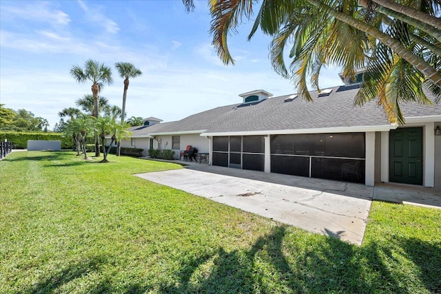 exterior space featuring an attached garage, a sunroom, and driveway