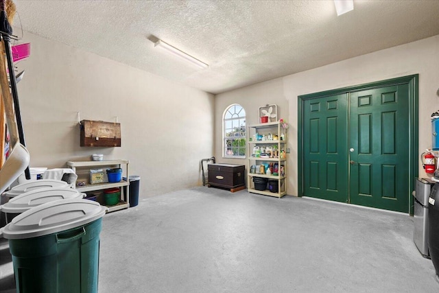 miscellaneous room with finished concrete flooring and a textured ceiling