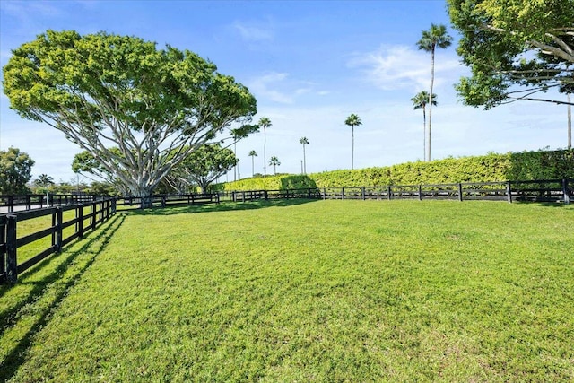 view of yard with a rural view and fence