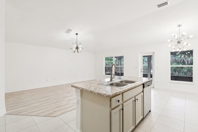 kitchen with a chandelier, a sink, open floor plan, stainless steel dishwasher, and an island with sink