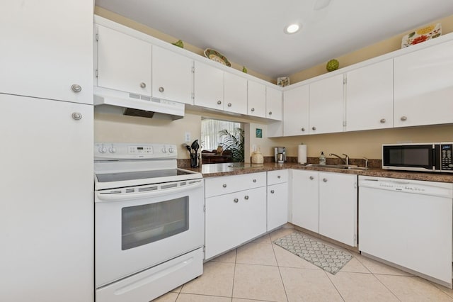 kitchen with white appliances, white cabinets, a sink, and under cabinet range hood