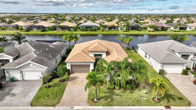 drone / aerial view featuring a water view and a residential view