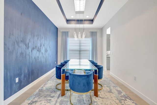 recreation room with baseboards, a raised ceiling, and recessed lighting