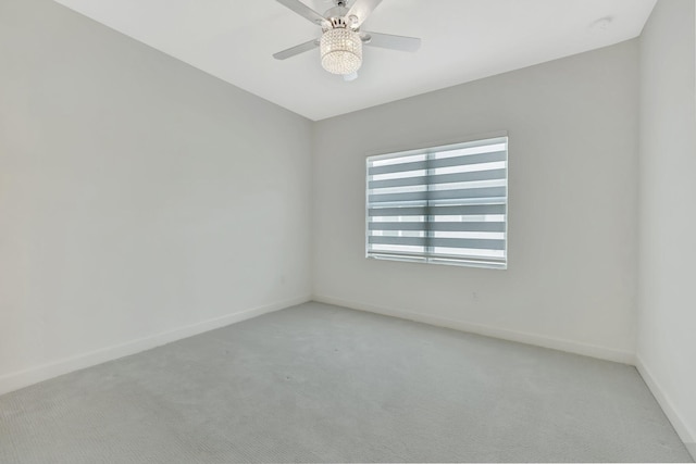 empty room with light carpet, ceiling fan, and baseboards