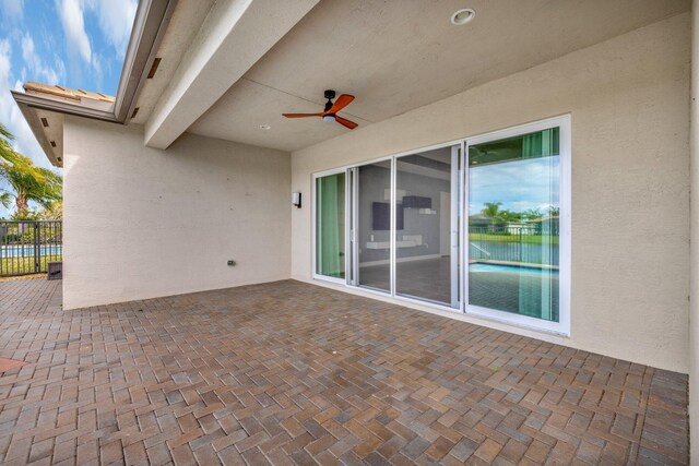 view of patio featuring ceiling fan and fence