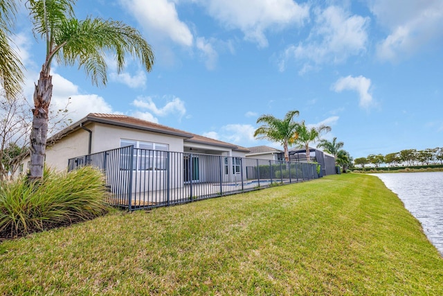 view of yard featuring a water view and fence