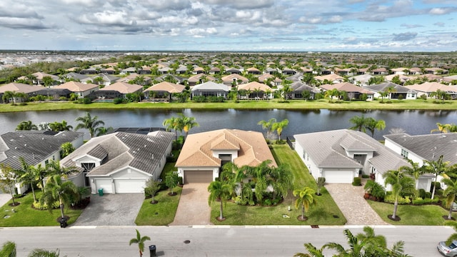 drone / aerial view featuring a residential view and a water view