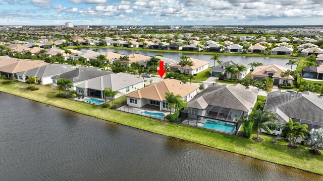 drone / aerial view with a water view and a residential view