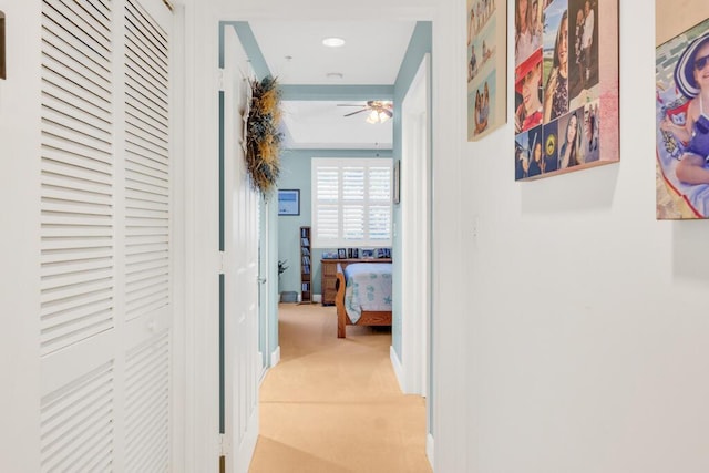 hallway with light carpet and baseboards