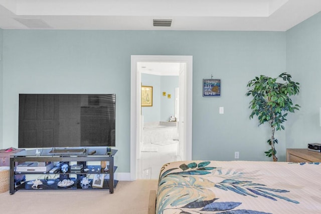 carpeted bedroom featuring connected bathroom and visible vents