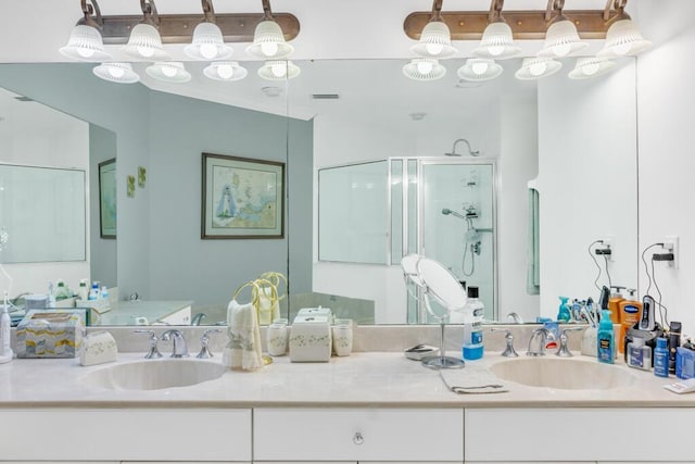 full bathroom featuring a stall shower and vanity