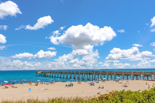 property view of water featuring a beach view and a pier