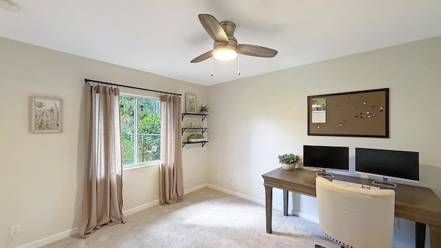 home office with ceiling fan, baseboards, and light colored carpet