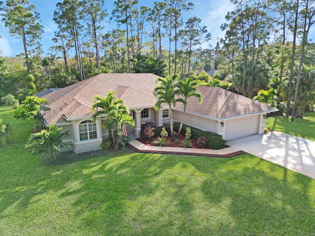 view of front of property with driveway, a shingled roof, stucco siding, an attached garage, and a front yard