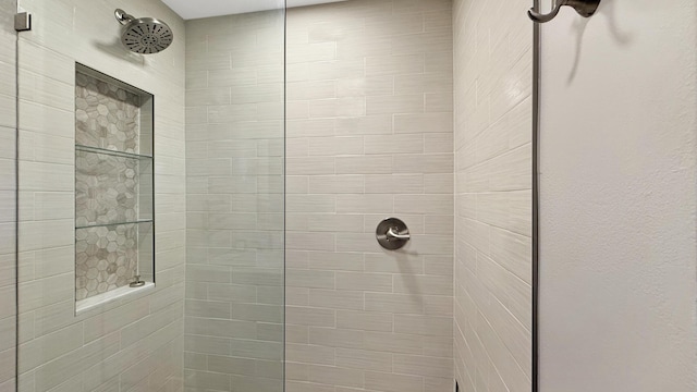 bathroom with tiled shower