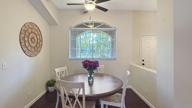 dining area with a ceiling fan and baseboards