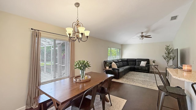 dining room with baseboards, visible vents, vaulted ceiling, and ceiling fan with notable chandelier