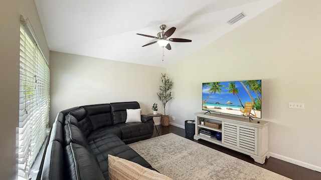 living area featuring lofted ceiling, ceiling fan, dark wood finished floors, and baseboards