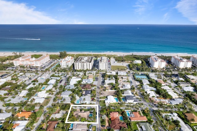 bird's eye view with a water view and a beach view