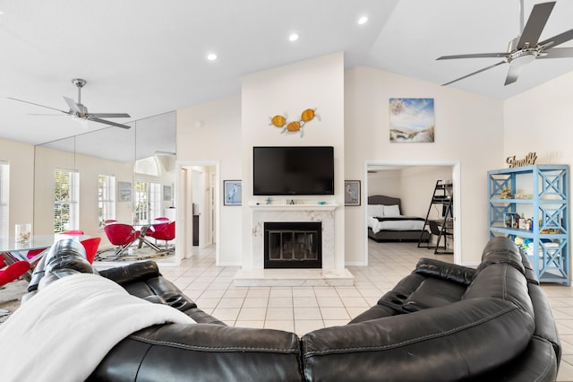 living area featuring light tile patterned floors, high vaulted ceiling, a fireplace, and a ceiling fan