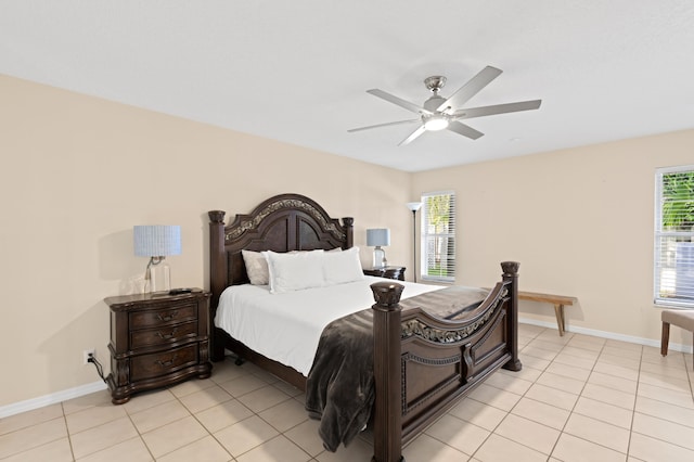 bedroom with multiple windows, light tile patterned flooring, and baseboards