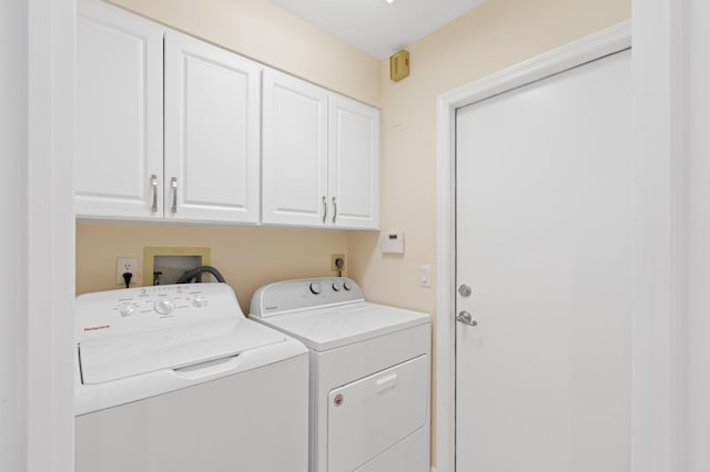 laundry area featuring cabinet space and separate washer and dryer