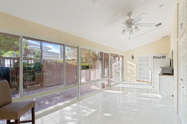 unfurnished sunroom featuring a ceiling fan, lofted ceiling, and visible vents