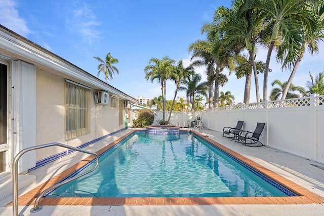 view of swimming pool with a pool with connected hot tub, a fenced backyard, and a patio