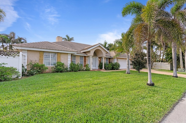 single story home featuring driveway, a chimney, a tiled roof, fence, and stucco siding