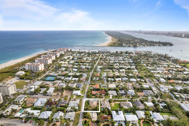 bird's eye view with a water view and a beach view