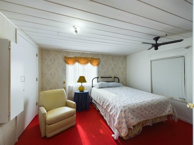 carpeted bedroom with ceiling fan and wallpapered walls