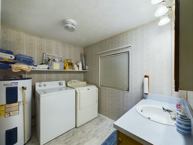 laundry area with water heater, a sink, washer and dryer, laundry area, and wallpapered walls