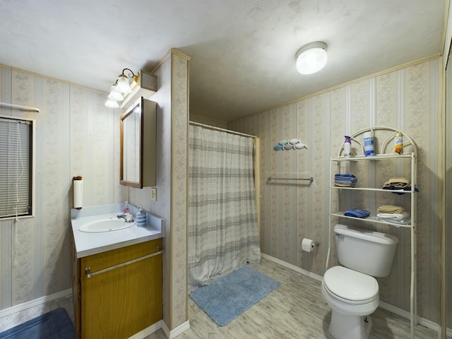 full bathroom featuring toilet, baseboards, vanity, and wallpapered walls