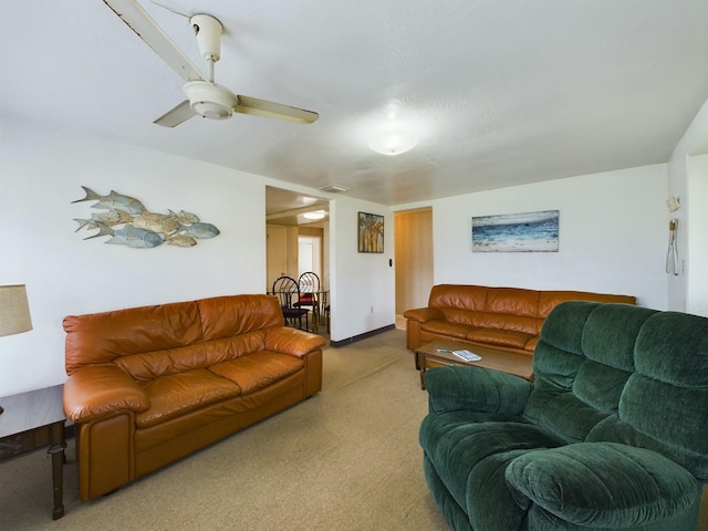 living room featuring light carpet, baseboards, visible vents, and ceiling fan