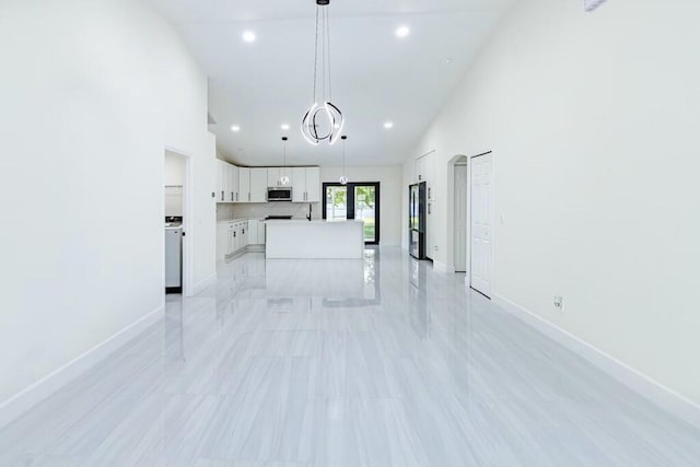 unfurnished living room with high vaulted ceiling, recessed lighting, and baseboards