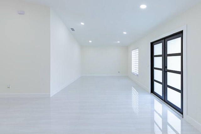 unfurnished room with recessed lighting, baseboards, and french doors