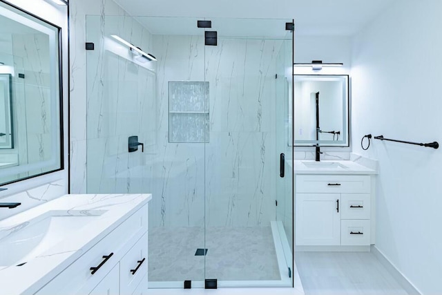 bathroom with a sink, two vanities, and a marble finish shower