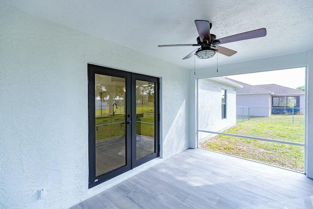 exterior space featuring a ceiling fan and french doors