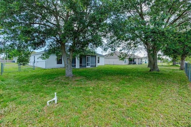 view of yard with a sunroom and a fenced backyard