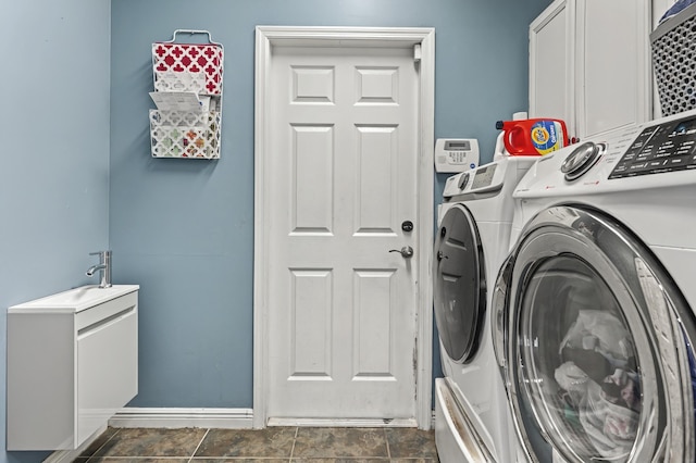 laundry room with washer and clothes dryer and cabinet space