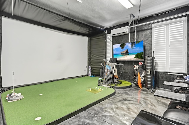 game room featuring a textured ceiling, an AC wall unit, golf simulator, and concrete floors