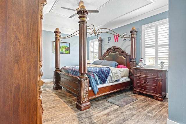 bedroom featuring baseboards, a ceiling fan, and light wood-style floors