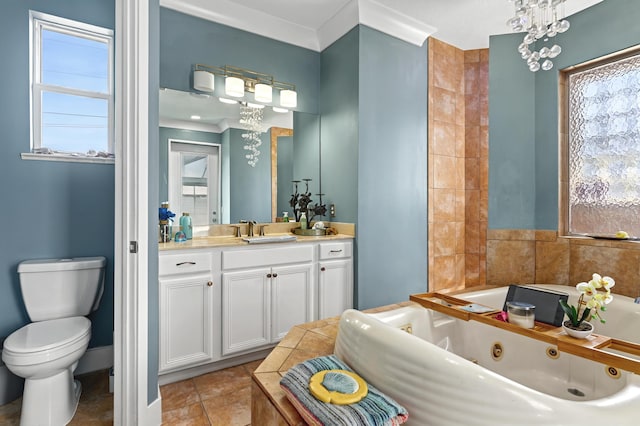 bathroom with toilet, vanity, a whirlpool tub, and tile patterned floors