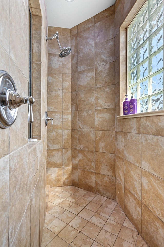 bathroom with tiled shower